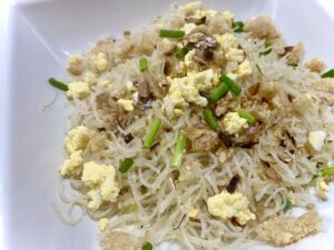 Pancit Puti is a Filipino noodle dish made with rice noodles, garlic, onion, and chicken, seasoned simply with salt and pepper—light, savory, and comforting.